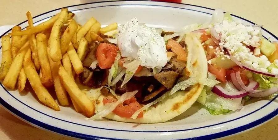 A food plate with french fries and vegetables